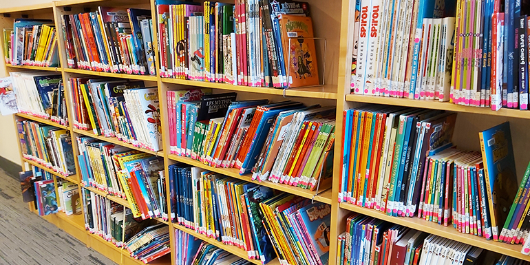 Colorful children's books on bookshelf