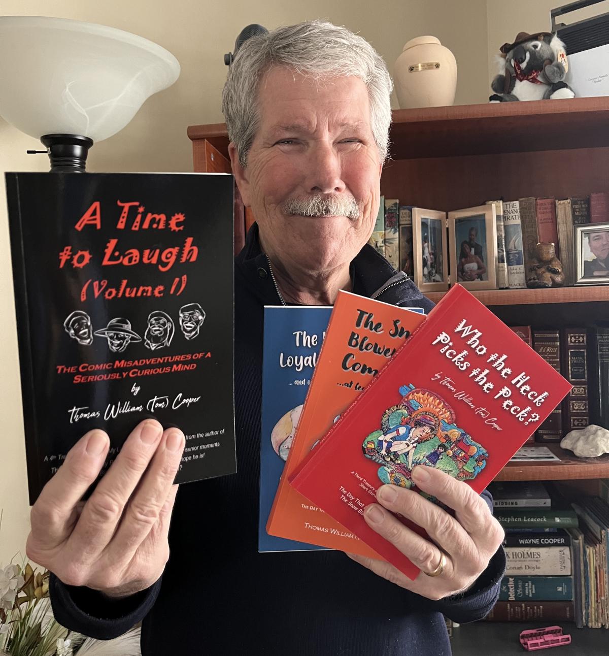 Tom Cooper holding his books